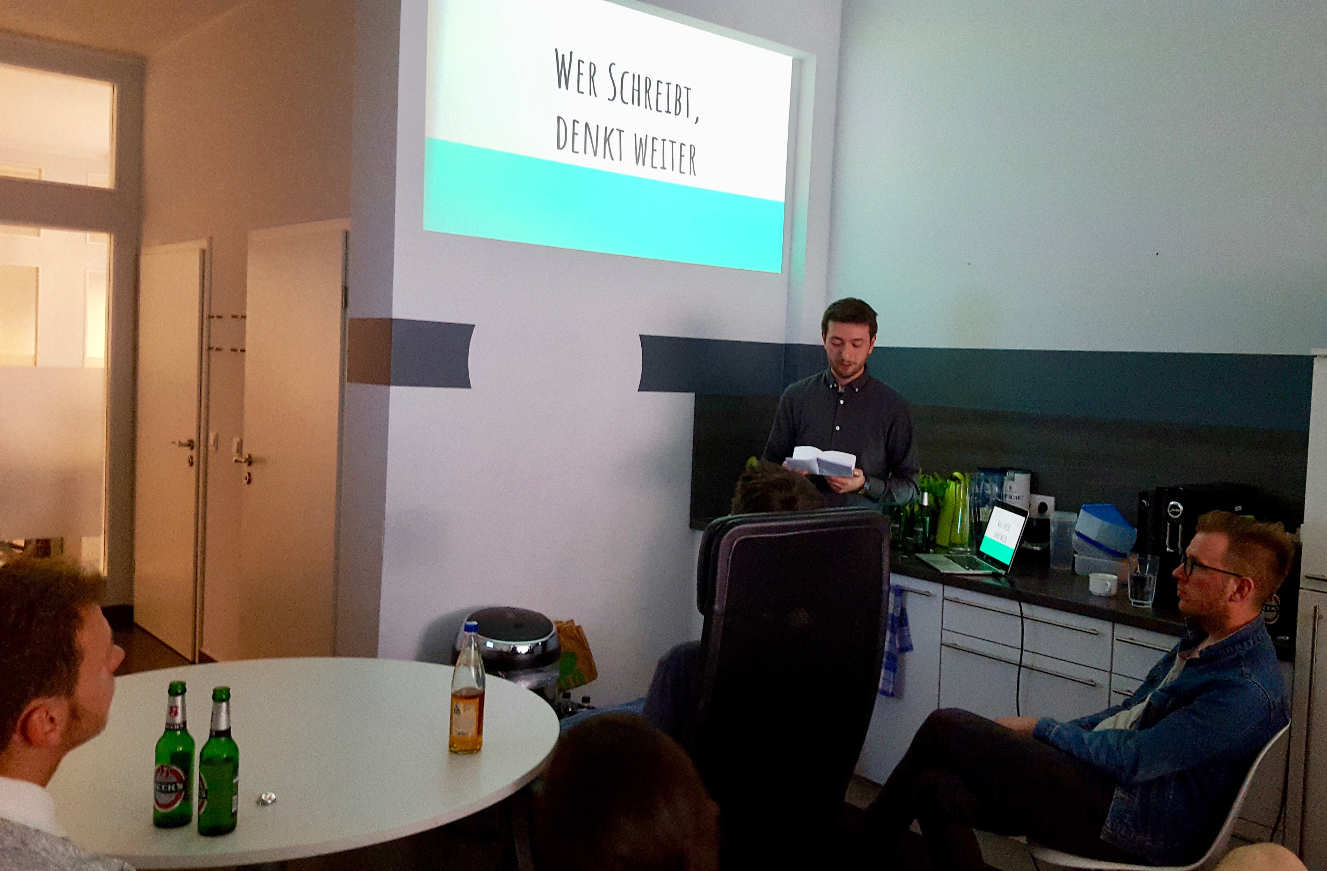 Photo of presentation on the benefits of writing at a Userlike Team event