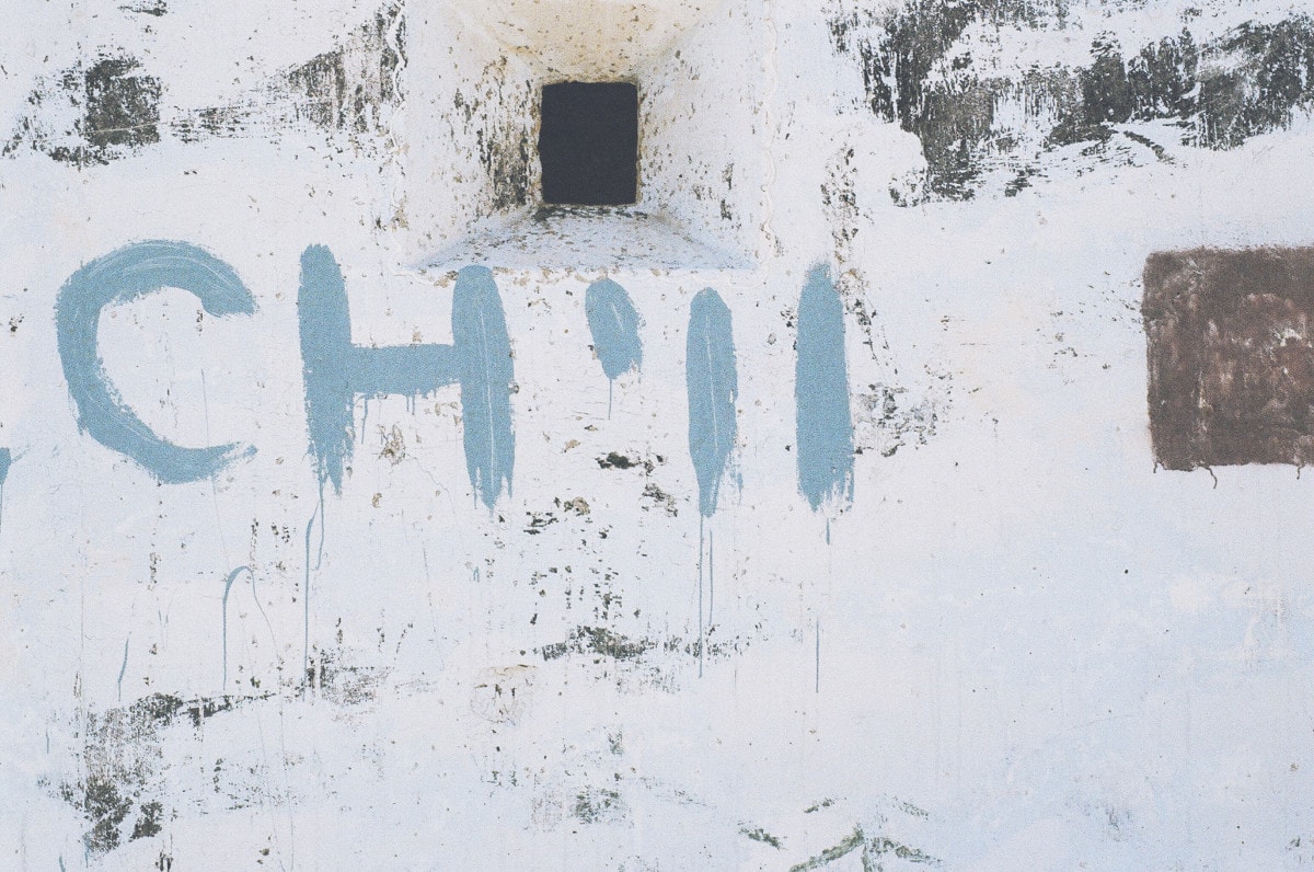 photograph picture of the word chill painted on a stone wall