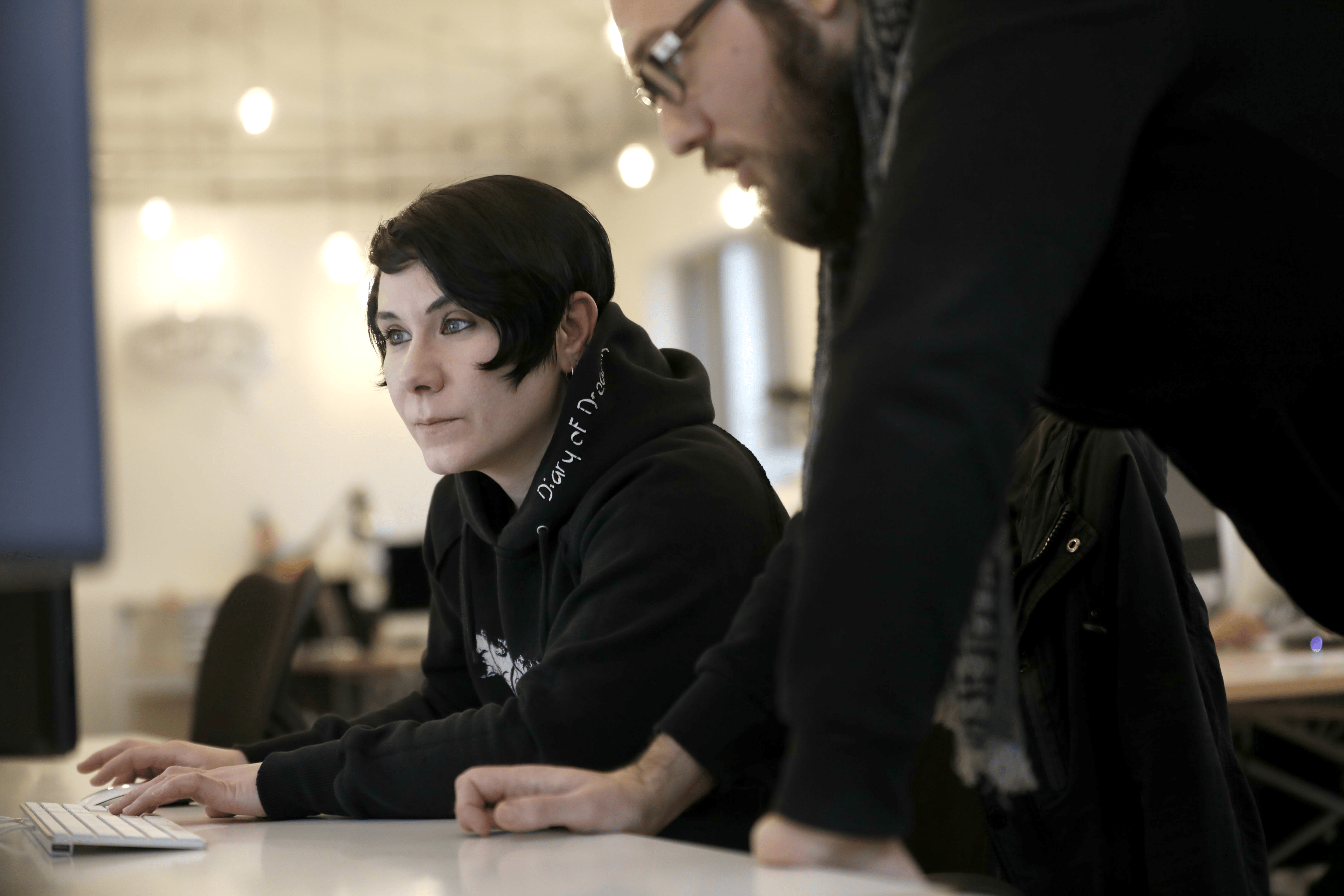 picture of customer success team members looking at a computer screen