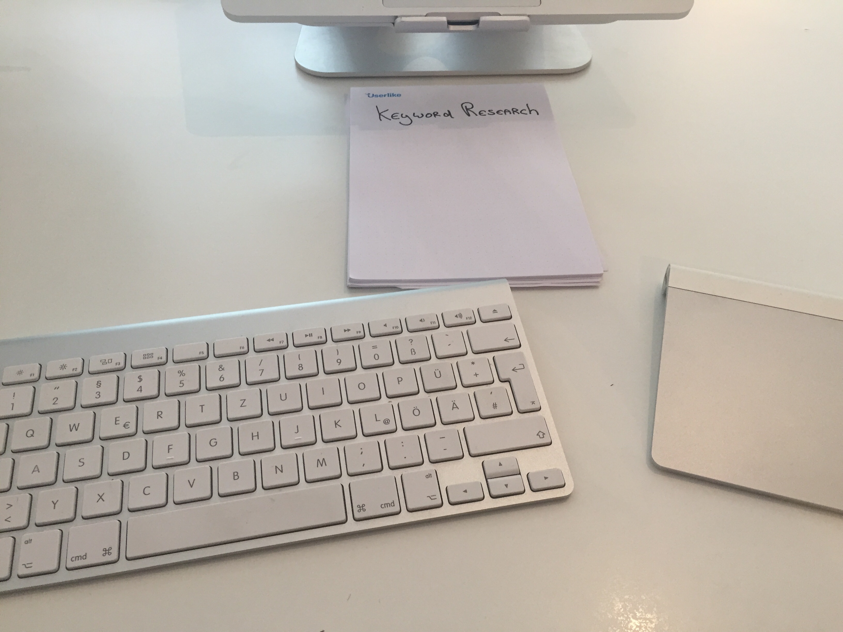 A simple notebook next to keyboard.