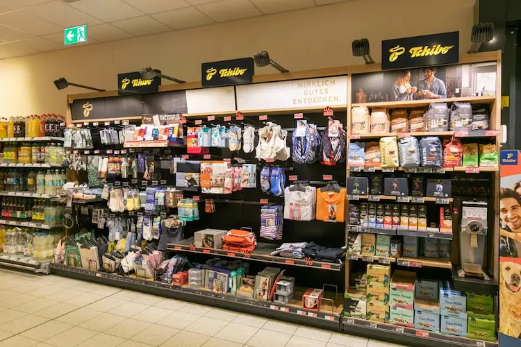 Tchibo product display at a Rewe grocery store