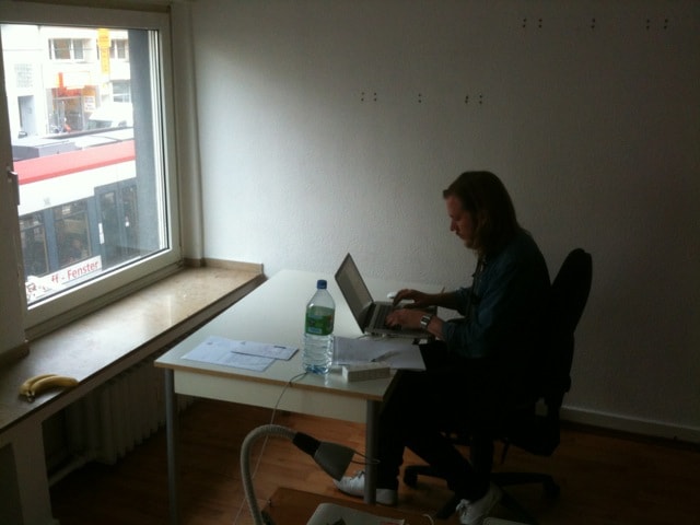 David sitting at his desk, writing code.