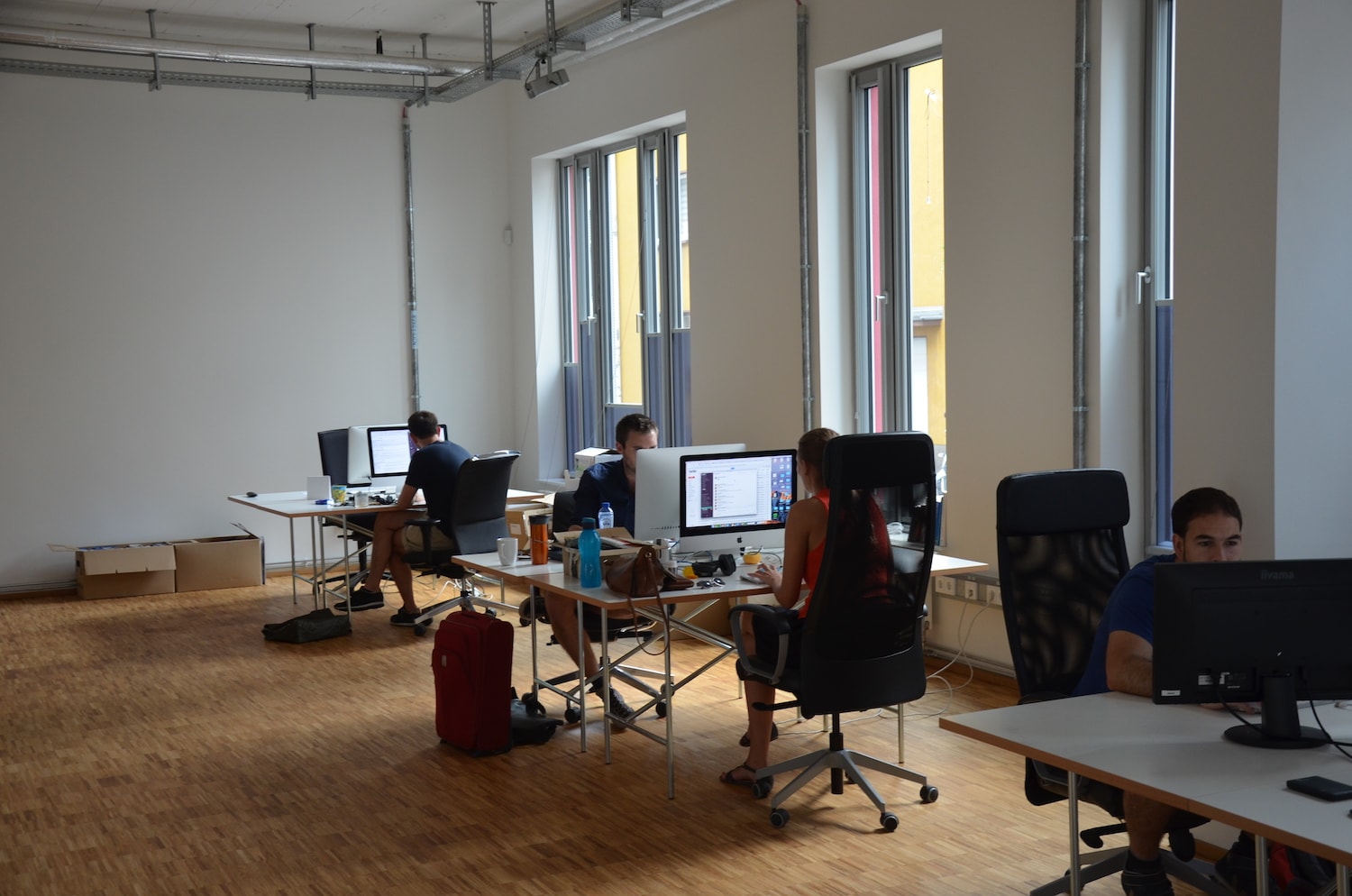 The marketing team sitting at their desks.