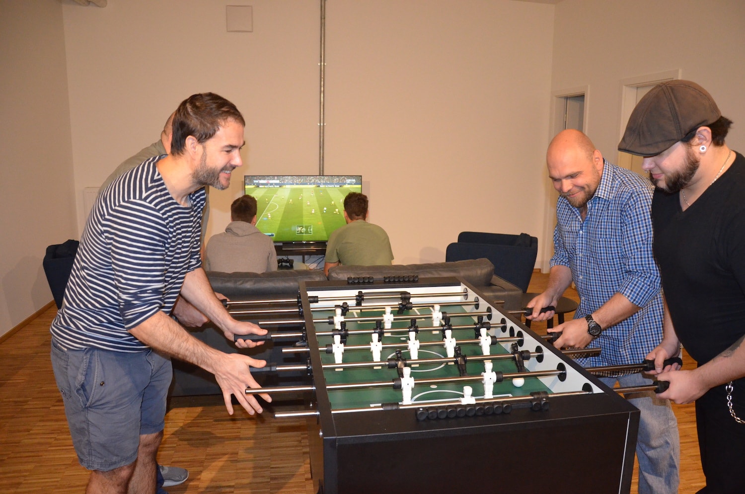 The team plays table foosball.