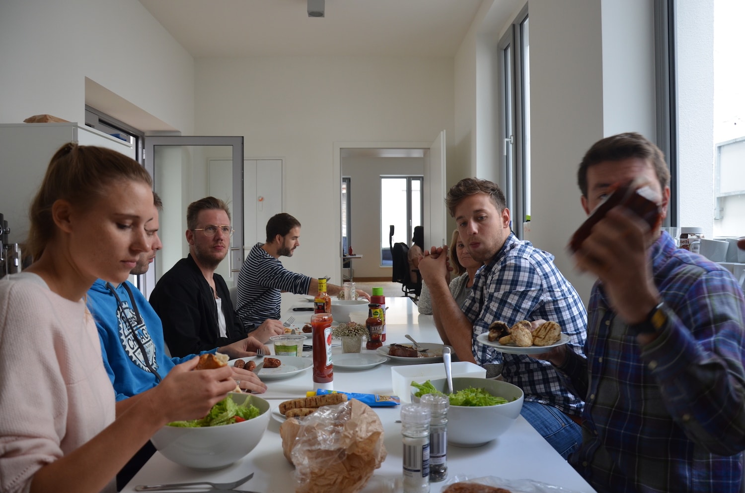 The team eating lunch in the kitchen.