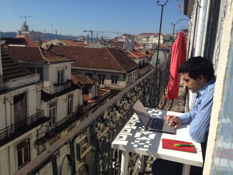 Timoor working from a balcony in Lisbon.