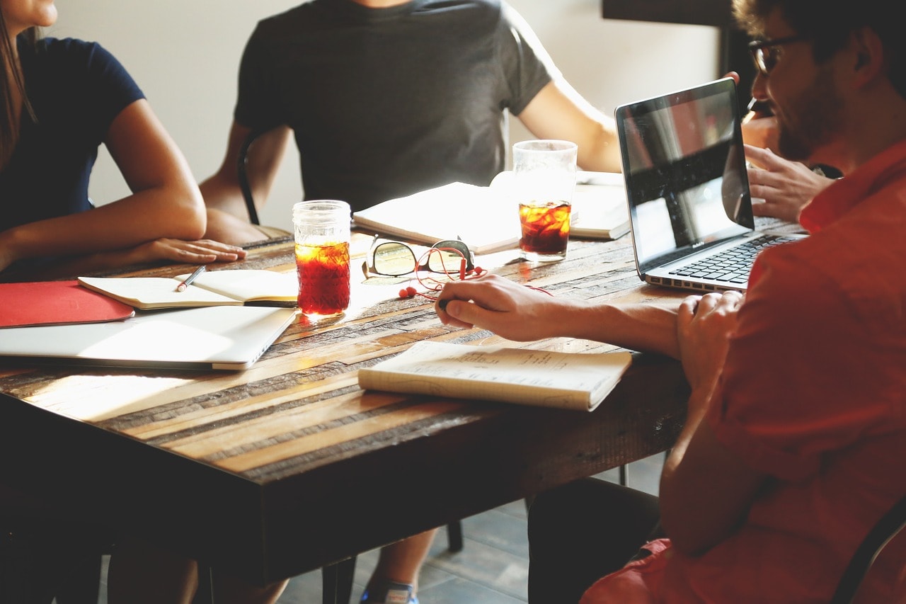 photograph picture of a four men sitting around table for meeting