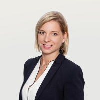 a woman with blonde hair wearing a black blazer and white shirt