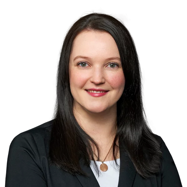 A woman smiling at the camera with a professional demeanor.